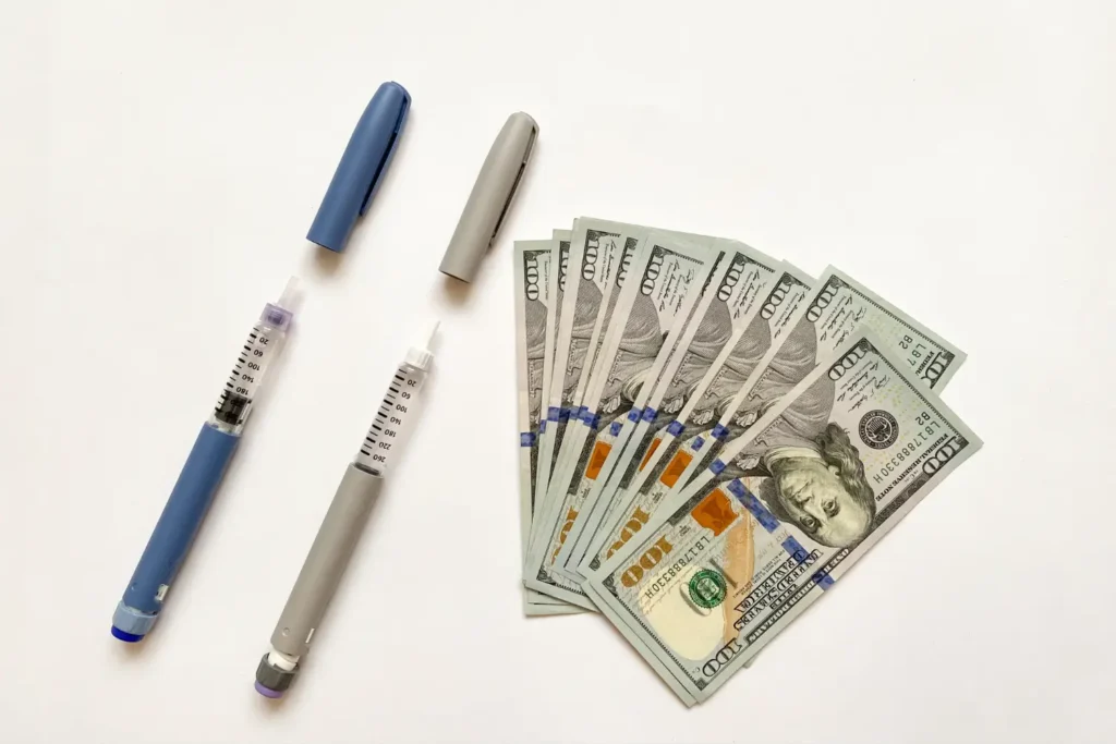 GLP-1 weight loss injection pens alongside a stack of money the cost of kansas city Semaglutide and Tirzepatide for Weight Loss